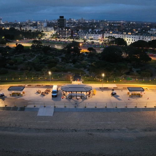 Aerial photo of beach front promenade in the evening, showing shelters