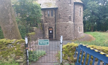 A before image of a black iron fence outside a church