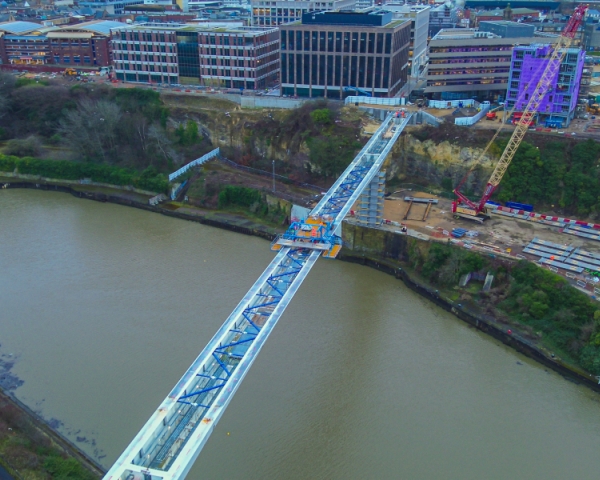 Picture of a steel bridge going across the water.