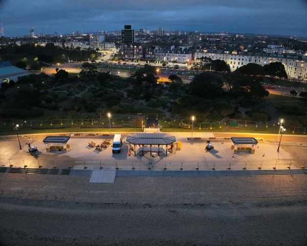 Aerial photo of beach front promenade in the evening, showing shelters